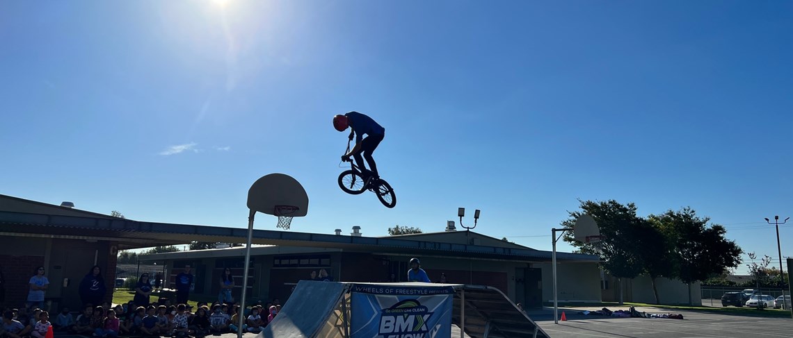 Students enjoy the show as Pro BMX riders show their skills
