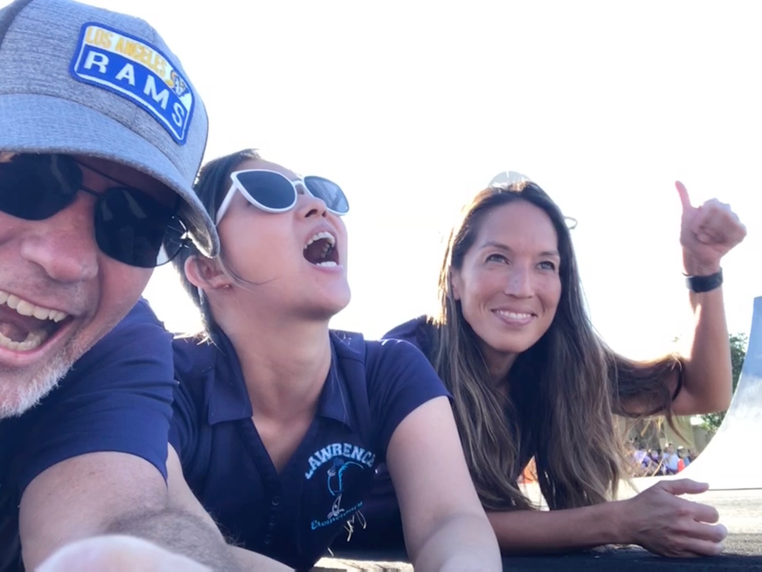 Mr. T, Ms. Pho, and Ms. Kawai prepare for BMX riders to jump over them